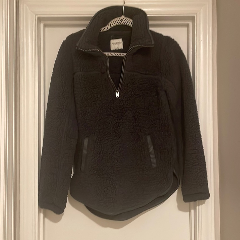 Dark grey faux fur pull over with faux leather accents.